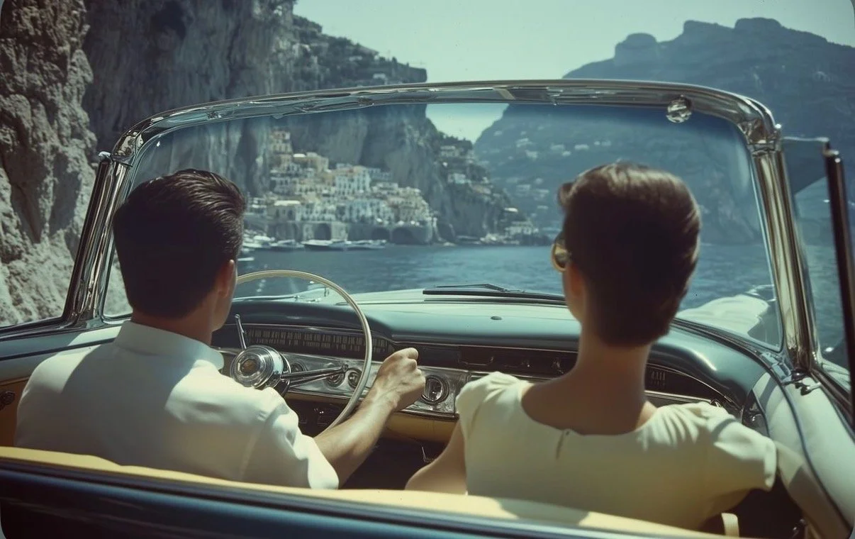 A couple driving a vintage convertible along the Amalfi coast